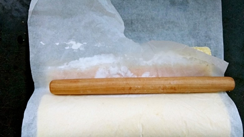 毛巾面蛋糕卷,卷的时候我一般是分两步,第一步就是直接带着油纸卷第一下(如图)然后把擀面棍放在那里用手牵拉油纸(先左边慢慢拉,然后中间,右边,一点点慢慢拉紧)目的是让卷可以圆润一些。最后直接顺势滚过去再利用擀面棍然后牵拉油纸定型。