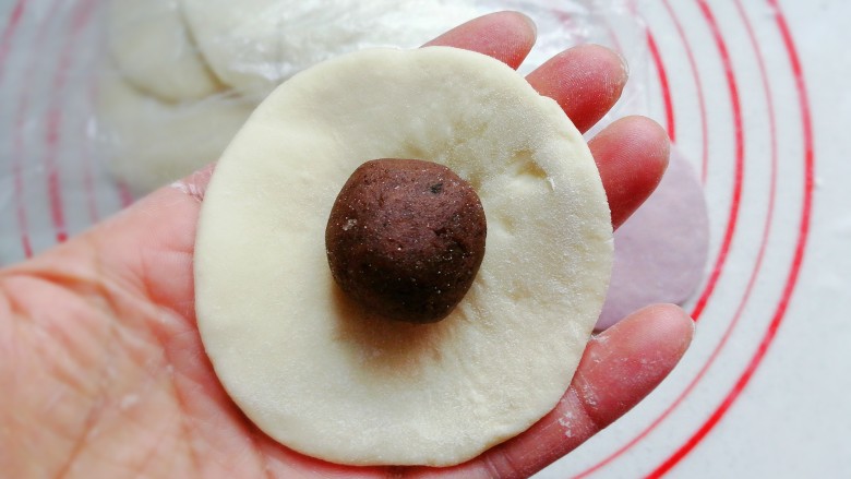 花式豆沙包,取一块圆面片,中间放上豆沙馅;