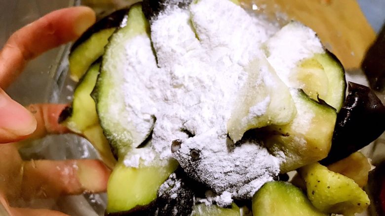 圆土豆~地三鲜,加入干淀粉搅拌均匀,让茄子都能够均匀沾满干淀粉。