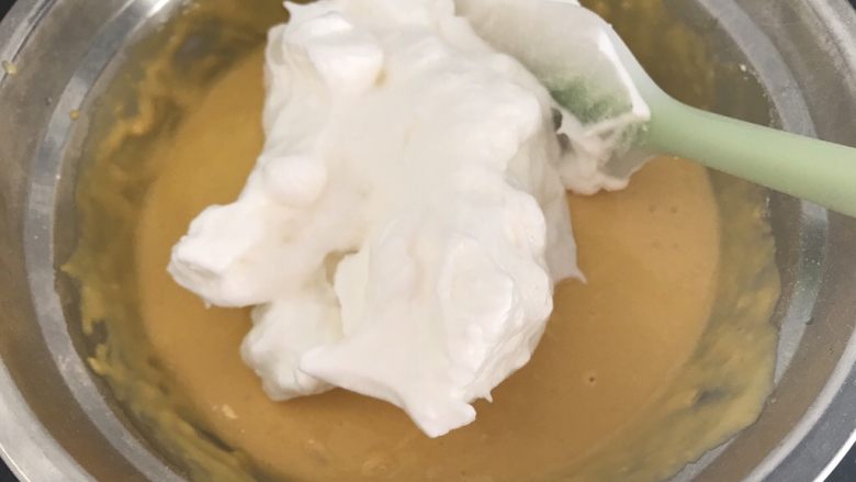 八寸南瓜戚风,然后挖1/3打发好的蛋白到拌好的南瓜糊里,翻拌均匀(切记不能打圈,会消泡导致蛋糕变蛋饼)
这时可以预热烤箱,135度5-8分钟
