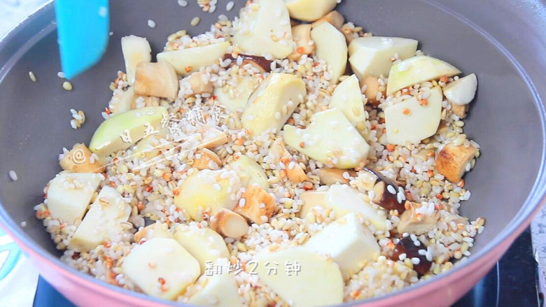 香菇芋头饭,放入杂粮米,加1小勺盐,翻炒2分钟。米一起炒了,煮出来的饭会更香哦。