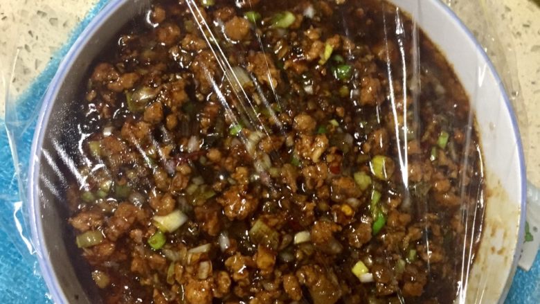 手工酱肉包,盛碗里,盖上保鲜膜!放入冰箱冷冻室,冷冻两小时!至软冻,这样包肉馅的时候好包一点,酱汁都可以包在露馅里,这一步非常关键!