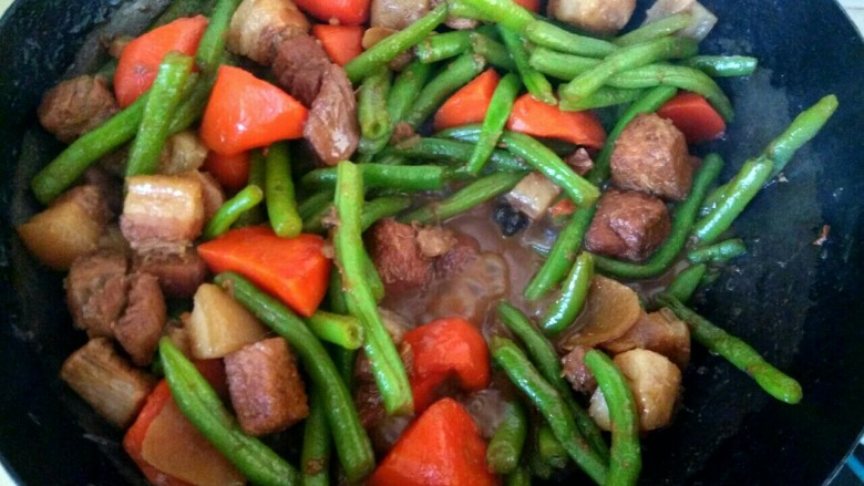 胡萝卜豆角炖五花肉,中火炖十多分钟,汤汁变粘稠,胡萝卜豆角熟透即可关火