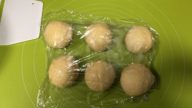 圣诞花环面包,取出面团按压排气,分割为等大的六份,盖上保鲜膜松弛15分钟