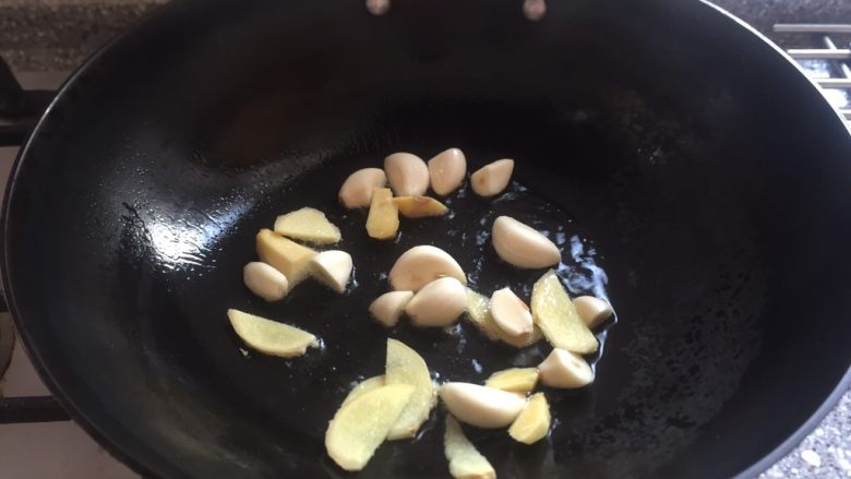 天冷必吃之一锅炖羊肉萝卜,煮过的水倒掉洗净烧热放入适量油,加入姜片,蒜瓣炒香。