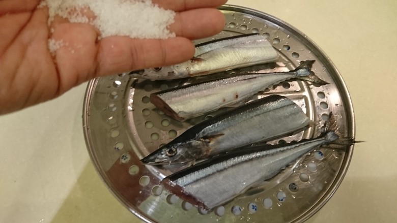 鹽巴燒烤秋刀魚,找個不會積水的容器,比如蒸網,魚放蒸網上頭,由高處撒海鹽,正反面都要。