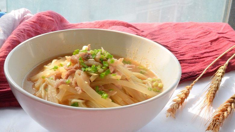 四川的面：酸萝卜肉丝面,先打一勺汤头，莫过铺好的菜上，再捞面条。如果大人吃，可以捞面条后过一道凉开水，这样口感更好。把面铺好后，加入汤头，没过三分之二面，再铺上料，最后细细的撒上葱花。