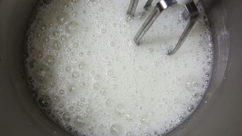 香橙戚风,打发蛋白霜前先预热烤箱,上火160度下火150度,不能分上下火的烤箱就180度预热。取出冷冻室的蛋白,中速打发至大泡泡,加入三分之一细砂糖