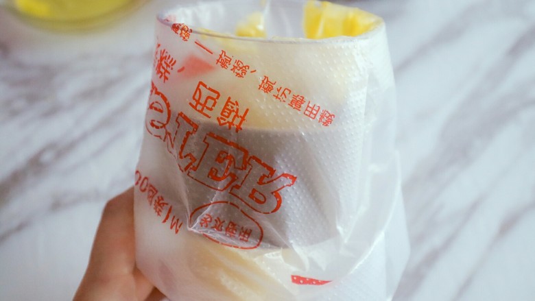 0失败蛋黄溶豆,糊糊装入裱花袋,最好用杯子套上装这样比较容易,这个时候烤箱开始预热,上下火100度