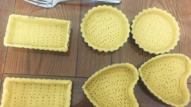 水果塔,然后用叉子在派盘中戳小洞洞后将派皮放入烤箱下层烤15分钟,上下火120度,最后5分钟将时间调到150度(每家的烤箱温度不一,按照自家的调整就好了)