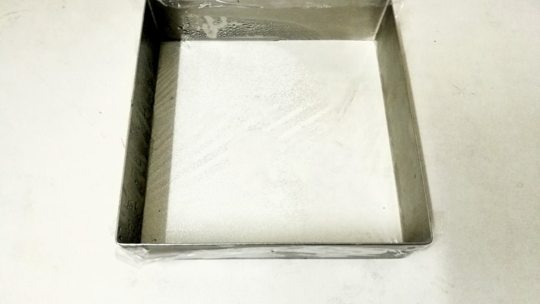简单易学—8寸芒果慕斯免烤蛋糕,黄油隔水融化好,和饼干碎充分拌匀,忘记拍照了,哈哈。我相信大家懂得,然后慕斯模具底部用保鲜膜包好。