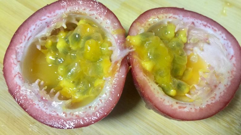 微波炉美食+百香蜜溏心蛋,把百香果立一下让果汁向下流,沿三分之一处切开