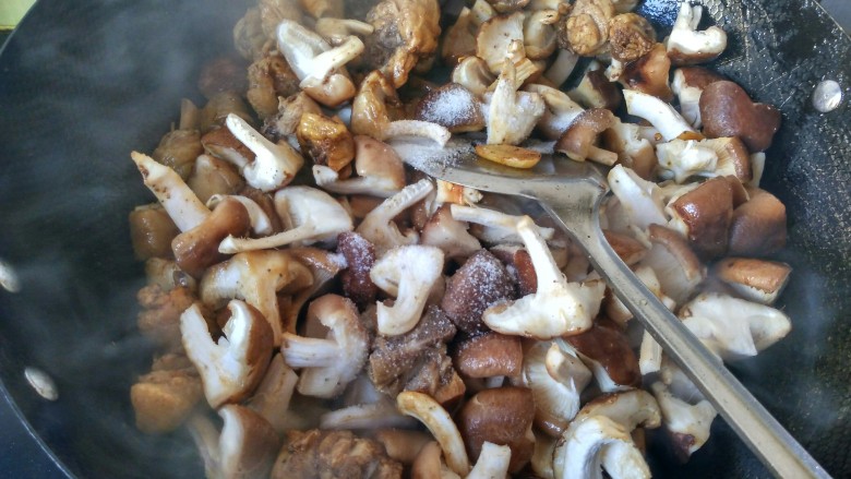 香菇滑鸡块,放盐,翻炒。