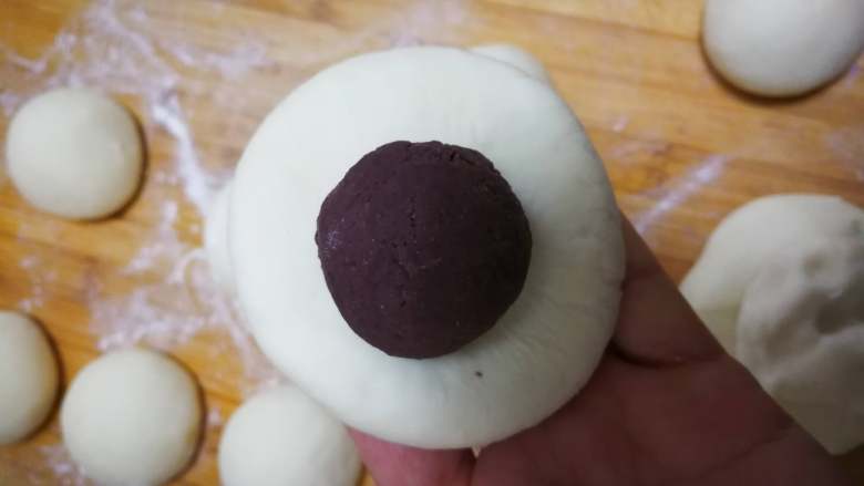 圆嘟嘟小刺猬—豆沙包,揉圆的白色面团压扁一点,分别包入豆沙馅。
