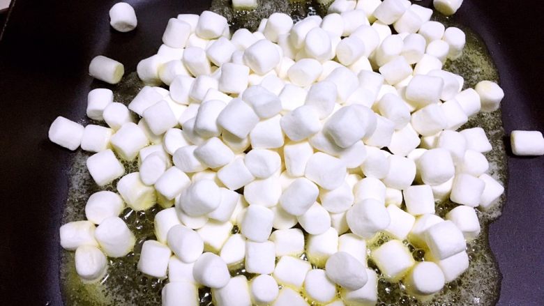 网红雪花酥,黄油全部融化后,倒入棉花糖,用刮棒翻炒至棉花糖融化