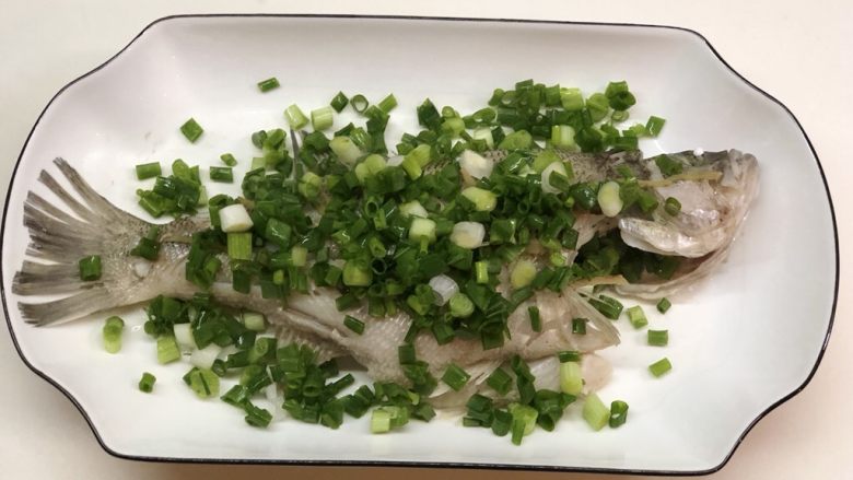 椒香葱油鲈鱼,取出鲈鱼,撒上葱花