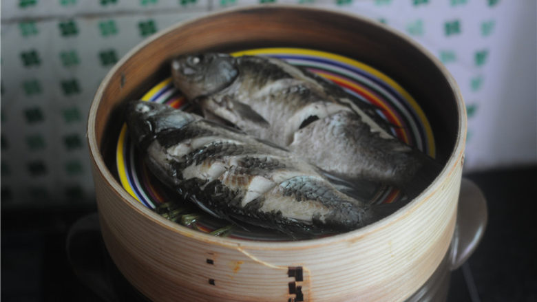 紫苏砂锅鲫鱼蒸,蒸好后,碟子里会有很多汤汁,将汤汁倒掉,鱼身下的紫苏杆去掉