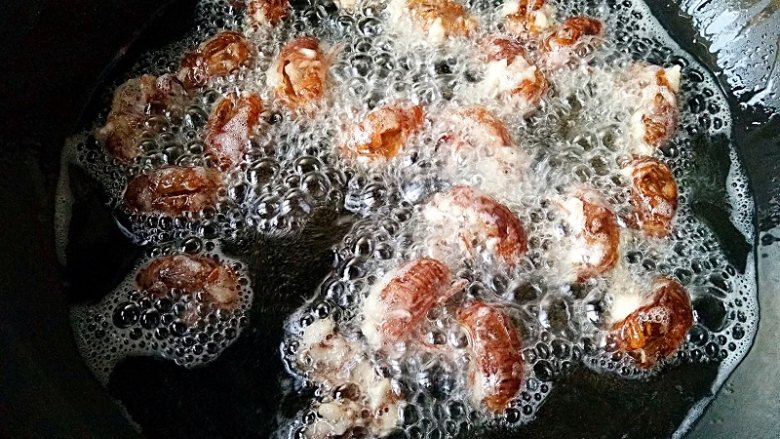 香酥蝉蜕 ,锅中宽油，烧至6成热，转小火，下入腌制好的蝉蜕。