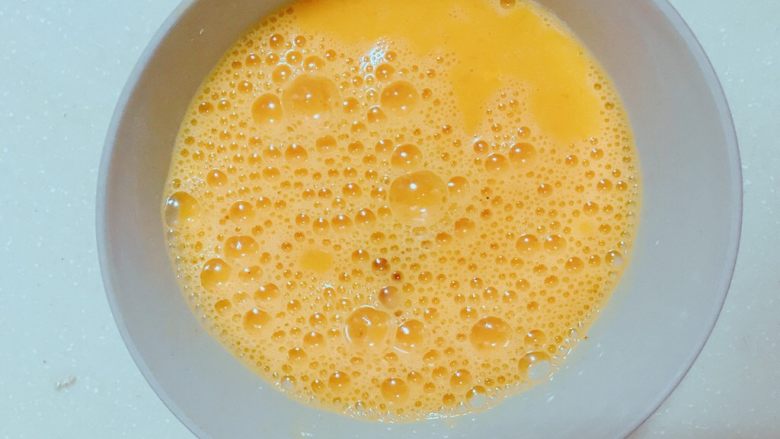 番茄鸡蛋私房面,鸡蛋三个碗里筷子打散。