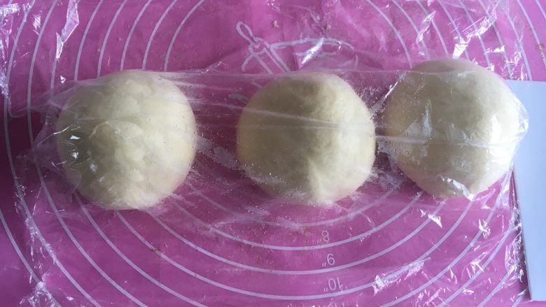 直接法经典淡奶油方吐司,平均分割成3份,分别滚圆盖保鲜膜松弛15分钟