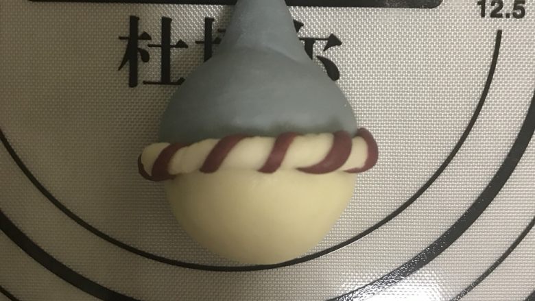 花式面点—圣诞雪人馒头,雪人头部抹点水,将搓好的条压住帽子边缘粘上