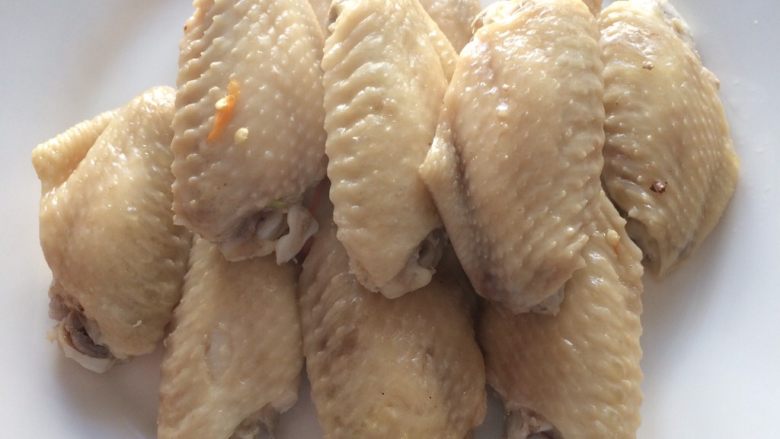 葱油鸡翅,将蒸好的鸡翅取出盛盘,并将青红椒丝铺在鸡翅上,将蒸出来的汤汁淋在鸡翅上,然后将大葱丝和姜丝铺在鸡翅上。