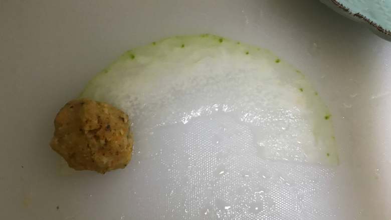 冬瓜鸡肉手捧花,取一片冬瓜片,铺上肉泥,瓜瓤的位置向下,顺时针卷出锥子形状。