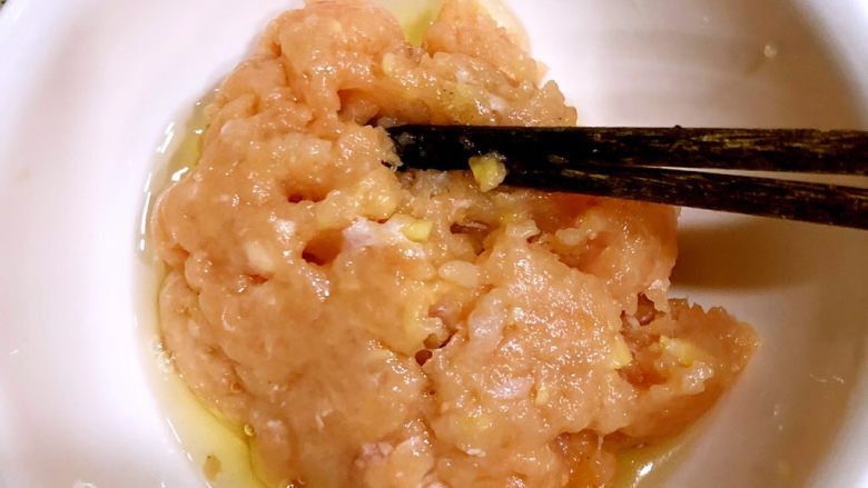 家庭版上校鸡块,蛋清倒入肉泥中,搅拌均匀。蛋黄留着备用。