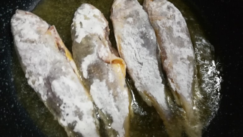 家常小黄鱼贴饼子,锅里倒去一些油,煎鱼。