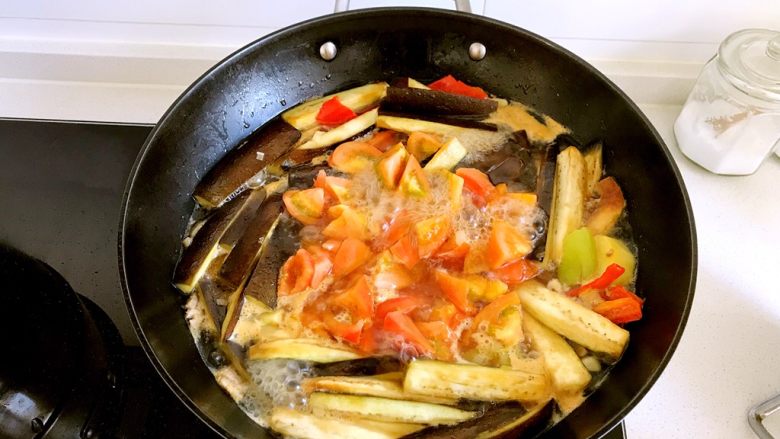 青红椒土豆茄子煲,炖到水开,将西红柿加入,继续大火炖,水再次烧开,往里面加盐,调至中火炖到土豆熟透,如果汤不够浓,这时可以开大火收汁,收到你满意的时候就可以关火了。
