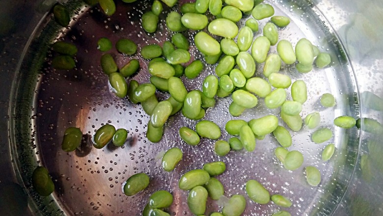 雪菜毛豆,将剥好的毛豆入开水焯一下,去豆腥味断生后,沥水捞出备用。