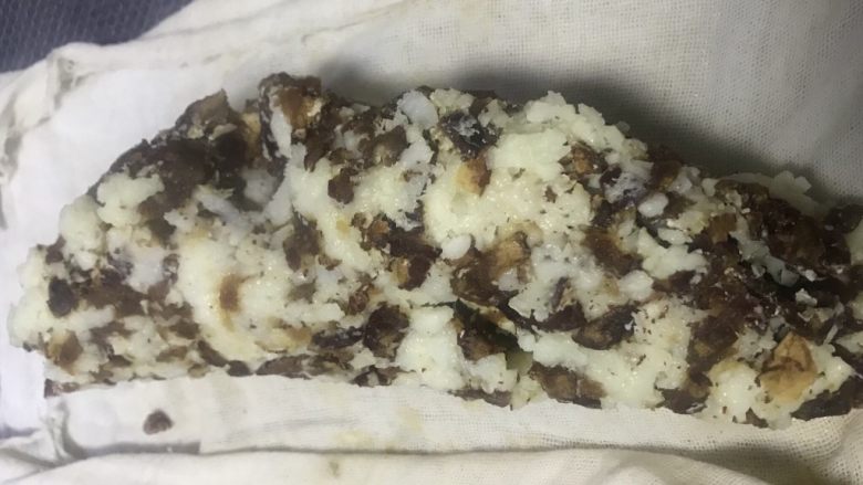 老北京清真小吃-糖卷果,将蒸好的卷果直接铺在寿司帘上,借用寿司帘将卷果弄紧实。此时的卷果比较烫,最好戴隔热手套处理。