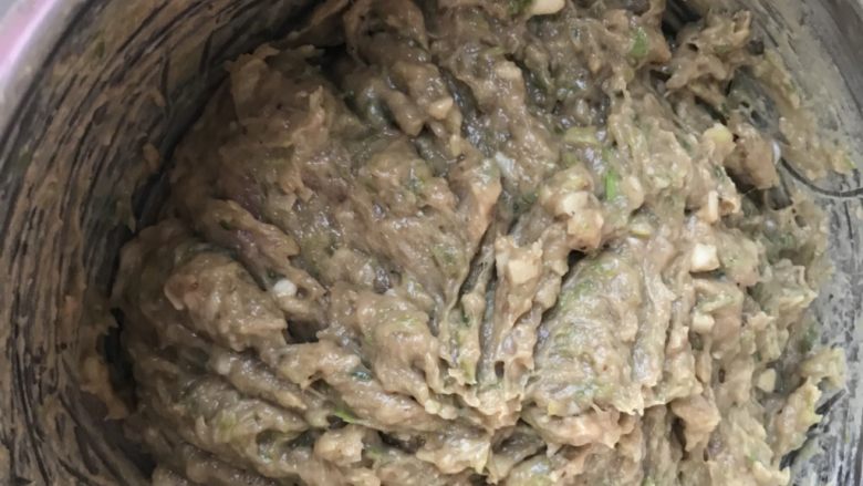 创新美味肉包子,放入适量的鲍鱼汁继续搅拌,这个时候馅料的水份比较少,搅拌起来比较费劲,拿半小碗凉水分三四次加入馅料里继续搅拌,这样肉糜可以充分吸收水份蒸出来的包子才会汁多鲜美、口感Q弹。