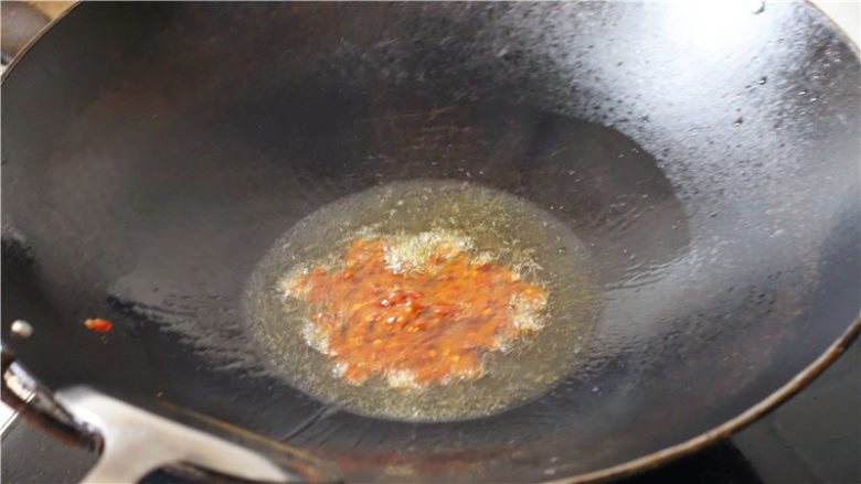 韭菜炒豆腐干,.锅里放适量食用油,烧至6成热,放入一勺<a style='color:red;display:inline-block;' href='/shicai/ 705'>豆瓣酱</a>,翻炒。