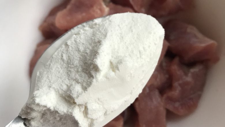 菠萝咕咾肉,腌好的肉放入三勺淀粉。