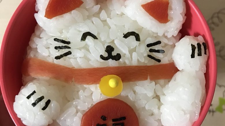 招财猫便当/饭团,把手臂饭团,小圆饭团放在主饭团合适位置,再用海苔剪出胡须、眼睛、鼻子等细节贴在合适位置,大致的过程就是如此