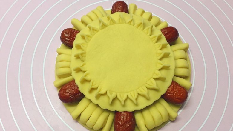 枣花馍,如图:把做好的花形圆饼放在枣花馍上。