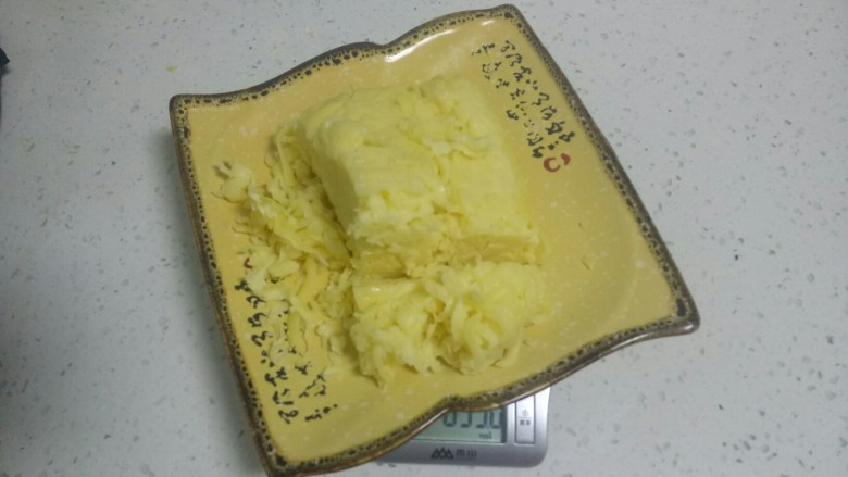 电饭锅蒸乳酪蛋糕,奶酪碎室温软化,用刀切碎。