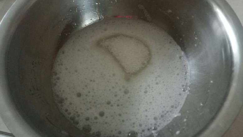 电饭锅蒸乳酪蛋糕,低速打发蛋白到有不规则泡泡时,加入1/3白糖。