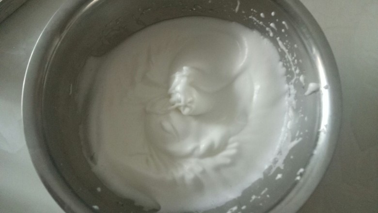 电饭锅蒸乳酪蛋糕,低速打发蛋白有明显纹路时,加入1/3白糖,打到湿性发泡状态,就是一个很有弹性弯勾状时就可以了。