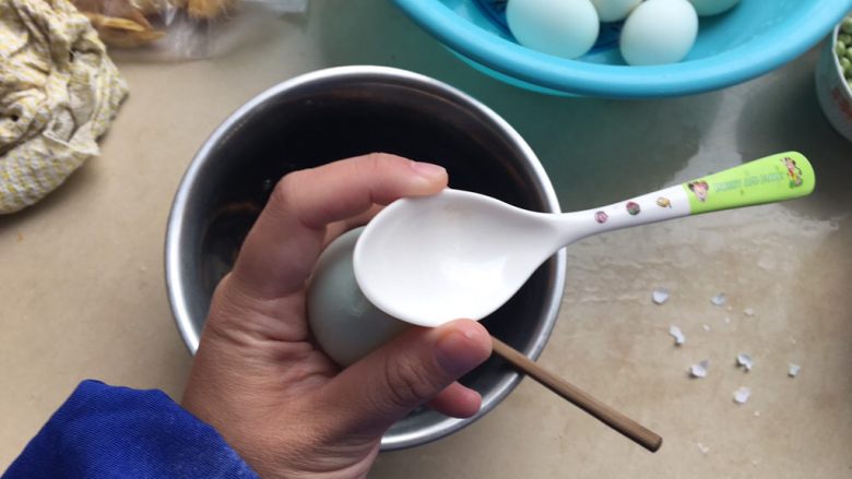 咸蛋超人—糯米蛋,用小勺子在咸蛋的顶部轻轻敲一敲,把顶端敲碎(记住记住咱们可是优雅的美人儿,一定要轻轻哦)