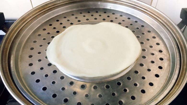 做饼+春饼(饺子皮版),锅上气后,在锅篦子上刷上一层油,放入两组的春饼,蒸10分钟就可以了。