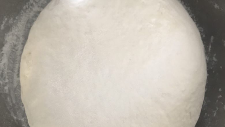 发面芝麻糖饼,揉成光滑的面团盖上保鲜膜,放到温暖处发酵。