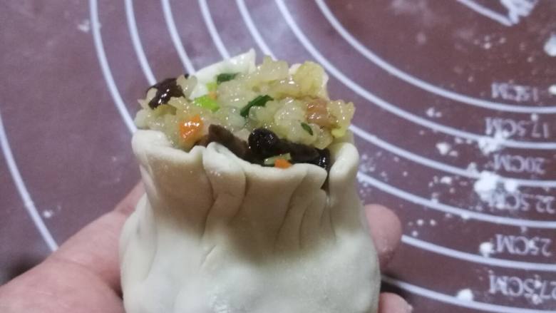 香肠香菇烧麦,在利用虎口,将烧麦收口,掐出腰身,一个烧麦就做好了。