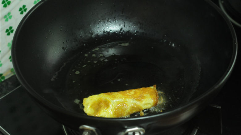 牛肉鸡蛋饺子,右手持铲子,左右用筷子帮忙,象裹被子一样将鸡蛋将肉馅裹起来。