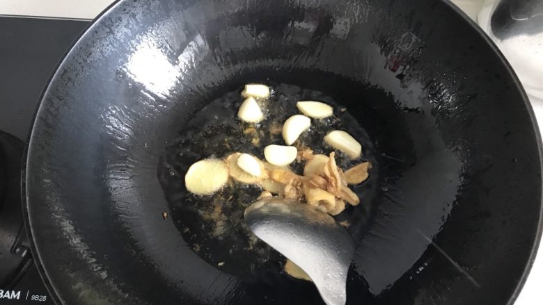 三杯鸡拌饭,加入大蒜瓣，大蒜不用切，蒜瓣就可以，然后在锅里炒出香味并且大蒜微微变黄。