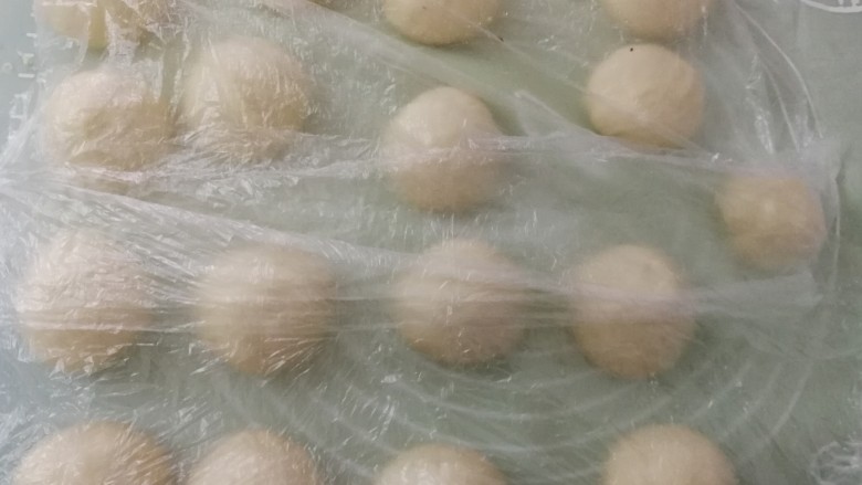 紫薯面包卷,分切为约55g的小剂子,滚圆后盖上保鲜膜松弛15分钟