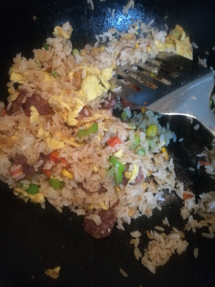 焗饭(广式香肠饭),鸡蛋超好后,再加油放米,香肠,葱花。翻炒。撒些生抽,和黑胡椒。