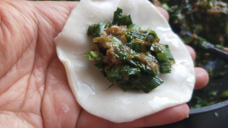 年夜饭 韭菜猪肉馅饺子,用清水给饺子皮抹一圈,放肉馅,大概六分满。