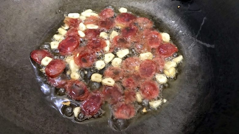 本地菜心蒜香木耳炒腊肠,转中火,煸炒至腊肠变色